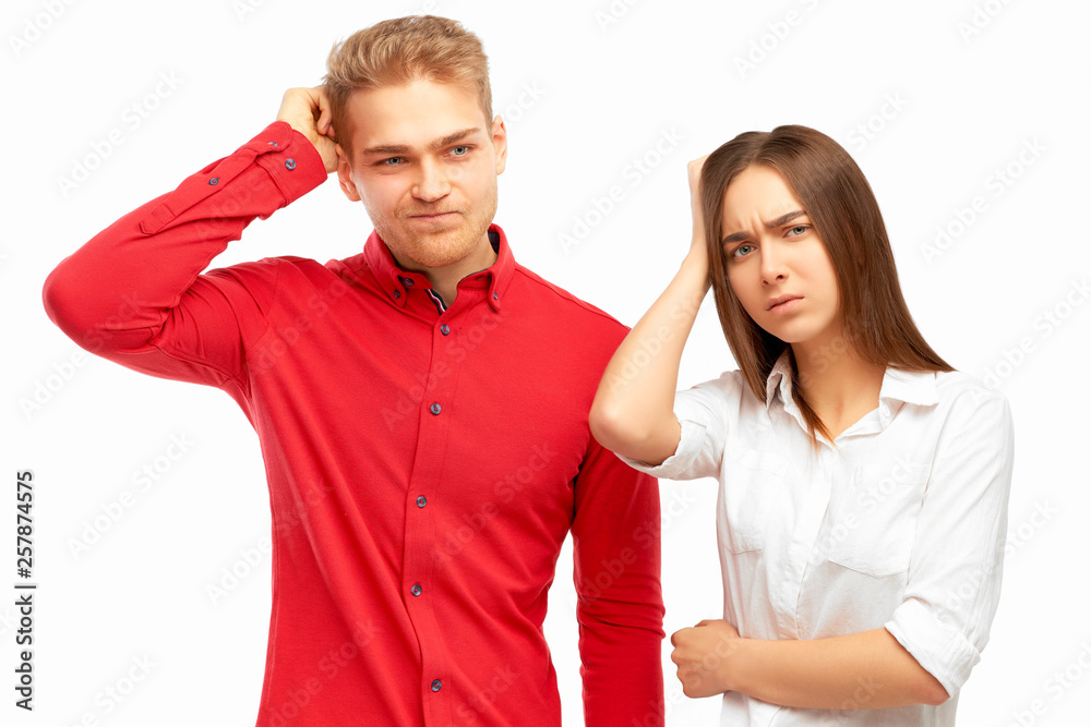 Attractive trendy young business people looking away with confused disappointed expression, scratching head, on isolated white background. Handsome entrepreneurs not remembers information on project Attractive trendy young business people looking away with confused disappointed expression, scratching head, on isolated white background. Handsome entrepreneurs not remembers information on project