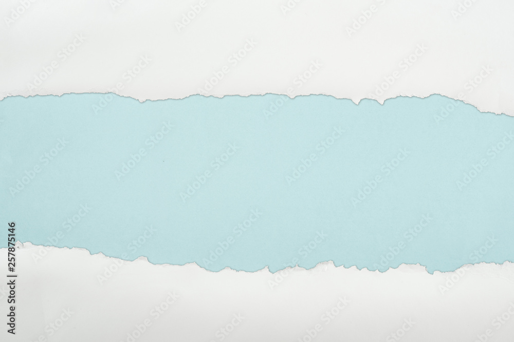 Obraz ripped white textured paper with copy space on light blue background