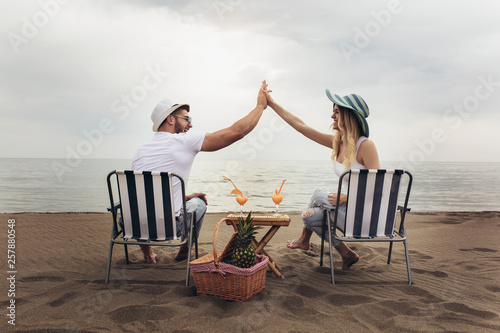 Couple on a deck chair relaxing on the beach. Happy couple enjoy on the beach during summer vacations © Mediteraneo