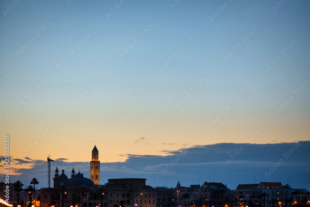 Panoramic view of cityscape in Bari, Italy. Romantic, calm, relaxing evening in city. Sun is setting over old town. Silhouette of cityscape.