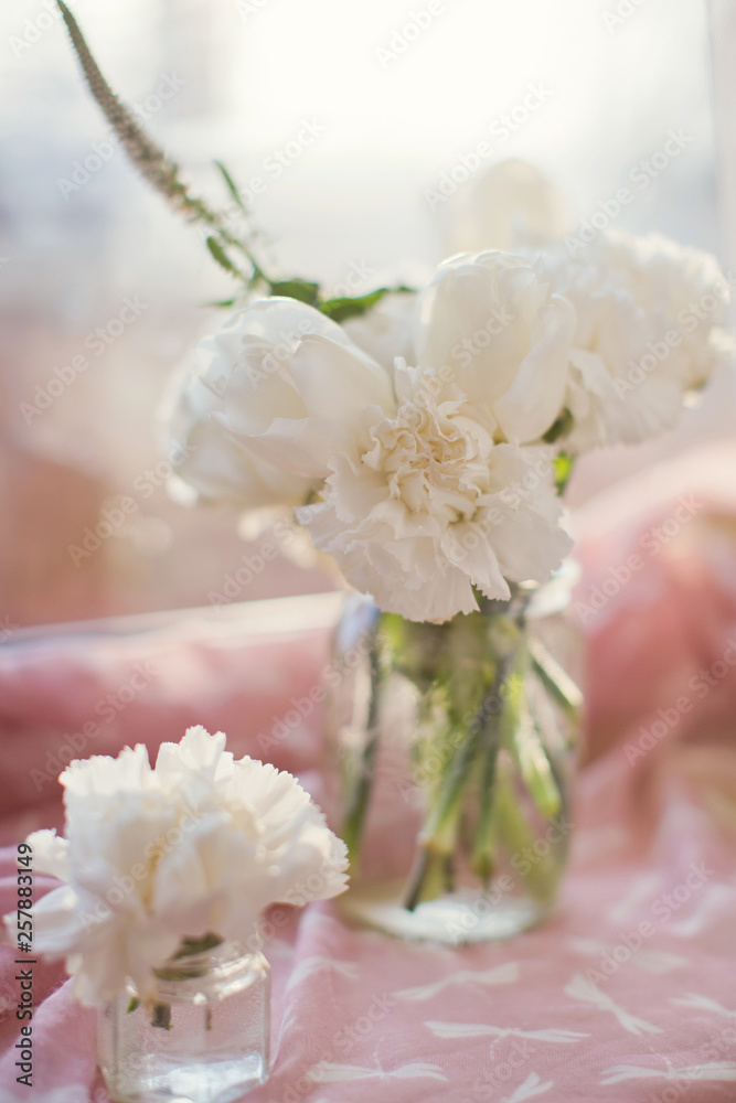 white carnations in glass jar white carnations in glass jar