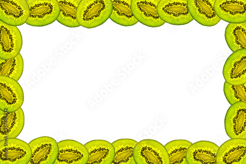 Frame made from fresh kiwi deliciosa on a white background with copy space in the middle. Overhead view, flatlay. Fruit background.
