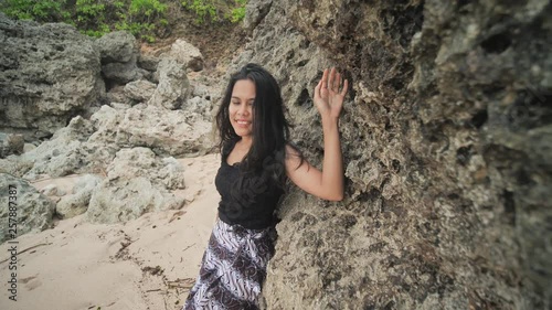 Indonesian girl posing on a beautiful and rocky beach in Bali. Idonezia. photo