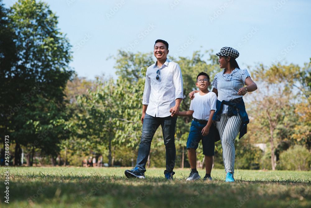 Happy children and parents playing in the park. Concept family relaxation. Happy children and parents playing in the park. Concept family relaxation.