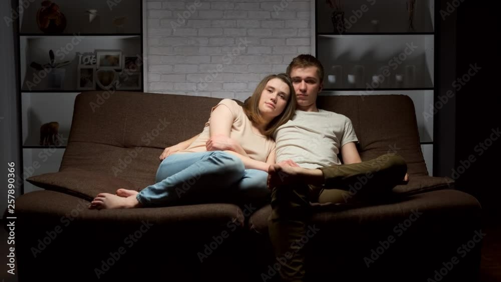 loving couple is sitting on the couch and watching TV. loving couple is sitting on the couch and watching TV.