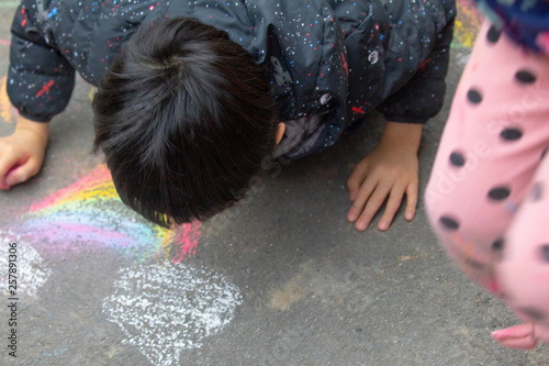 Outdoor kids graffiti on the floor with chalk