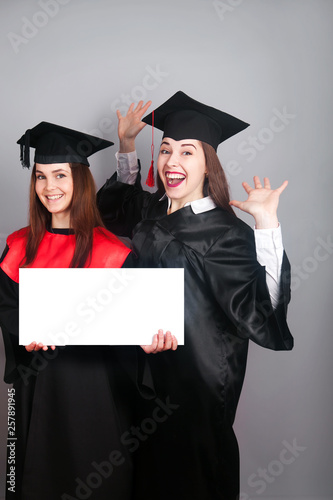 group of happy students holding blank board 