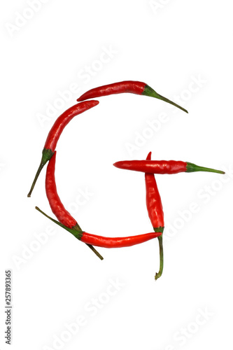 Alphabet of hot spice cayenne chili peppers isolated on white. Natural vegetarian diet organic vegetable chili peppers in shape of letter G, for making words and using as a logo © Наталия Чубакова