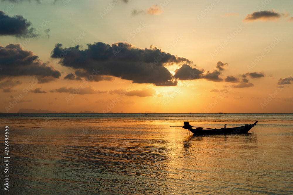Silhouette fishing boat with water reflection on sunset time background,