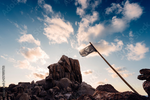 Fotografie, Obraz coastal landscape of rocks with pirate flag