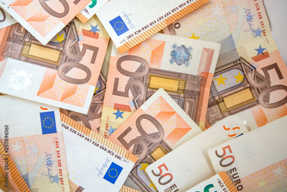 50 euro paper money and coins background. Hundreds of banknotes. Concept of cash flow, finances, rich people, business growth, success and development and millionaire 50 euro paper money and coins background. Hundreds of banknotes. Concept of cash flow, finances, rich people, business growth, success and development and millionaire