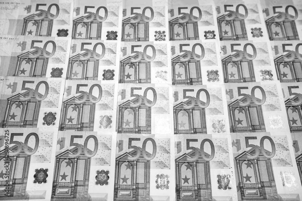 50 euro paper money on black background. Hundreds of banknotes. Concept of cash flow, finances, rich people, millionaire and successful business. 