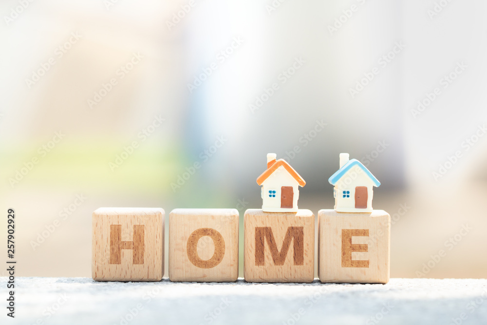 Two miniature house model on wooden block text dream. Business, finance, and saving money for dream house concept