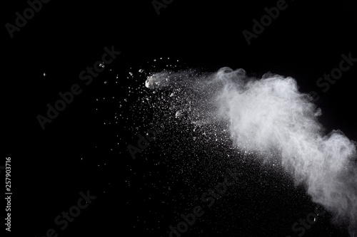 Abstract white powder explosion against black background.White dust exhale in the air.