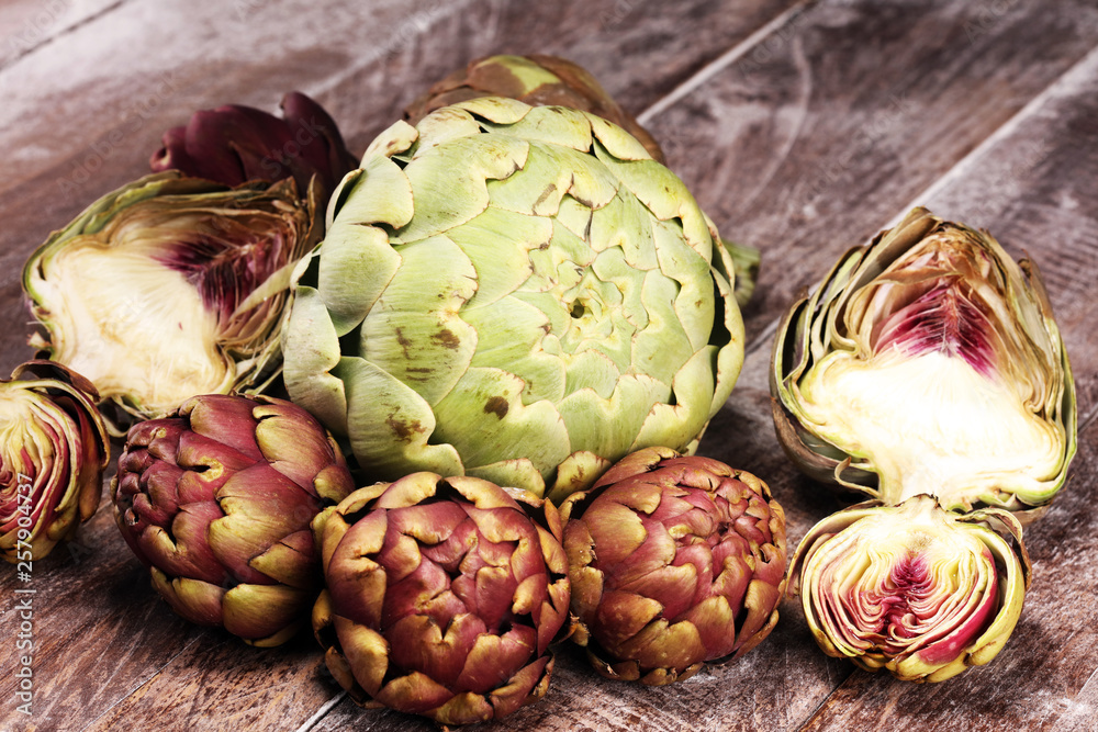 Fototapeta premium artichokes on grey background. fresh organic artichoke flower vegetable