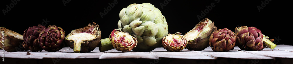Obraz premium artichokes on grey background. fresh organic artichoke flower vegetable