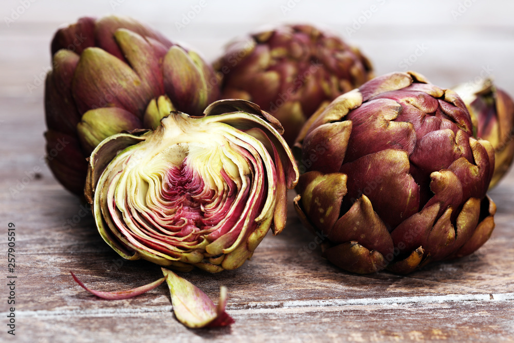 Obraz premium artichokes on grey background. fresh organic artichoke flower vegetable