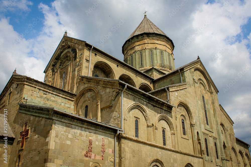 Svetitskhoveli (life-giving pillar) is the cathedral patriarchal temple of the Georgian Orthodox Church. UNESCO heritage. Georgia, Mtskheta. Church, built with a tower and arches. Blue sky with clouds