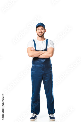 handsome mover in uniform with arms crossed looking at camera isolated on white