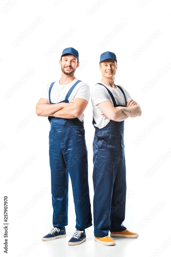 two smiling movers in uniform with arms crossed looking at camera on white two smiling movers in uniform with arms crossed looking at camera on white