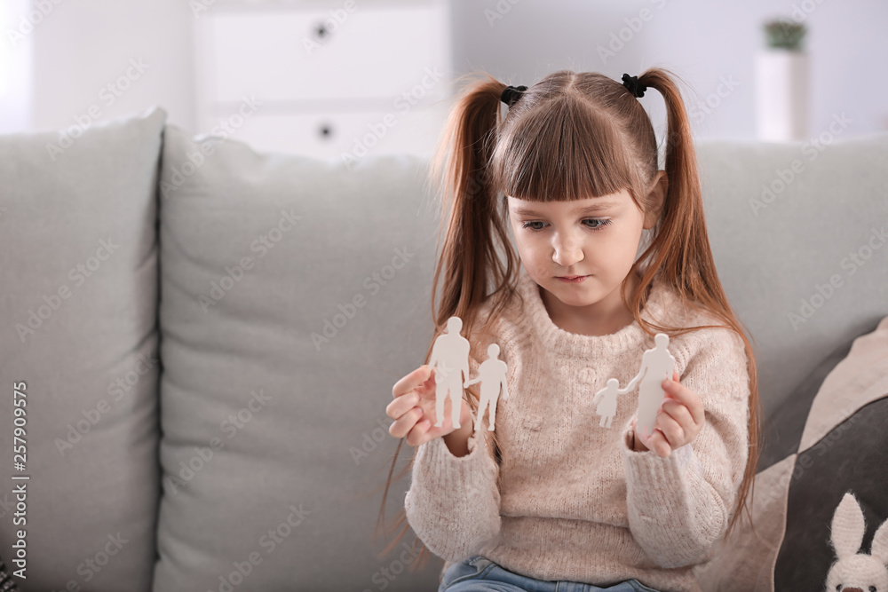 Little girl holding broken figure of family at home. Divorce concept Little girl holding broken figure of family at home. Divorce concept