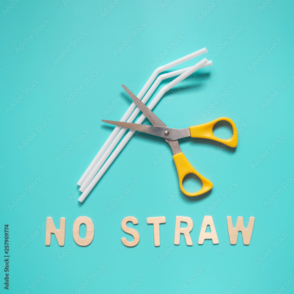Foto de Stop using plastic straws concept Yellow metal scissors cut