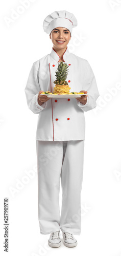 Young female confectioner with tasty dessert on white background