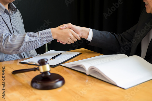 Law and Legal concept, Consultation between attorneys and clients customer shaking hands discussing contract agreement In Courtroom.