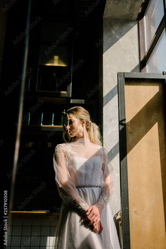 Bride in white wedding dress posing indoors Bride in white wedding dress posing indoors