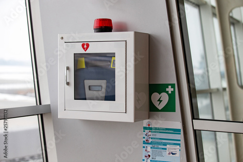 defibrillator attached to the wall at the airport