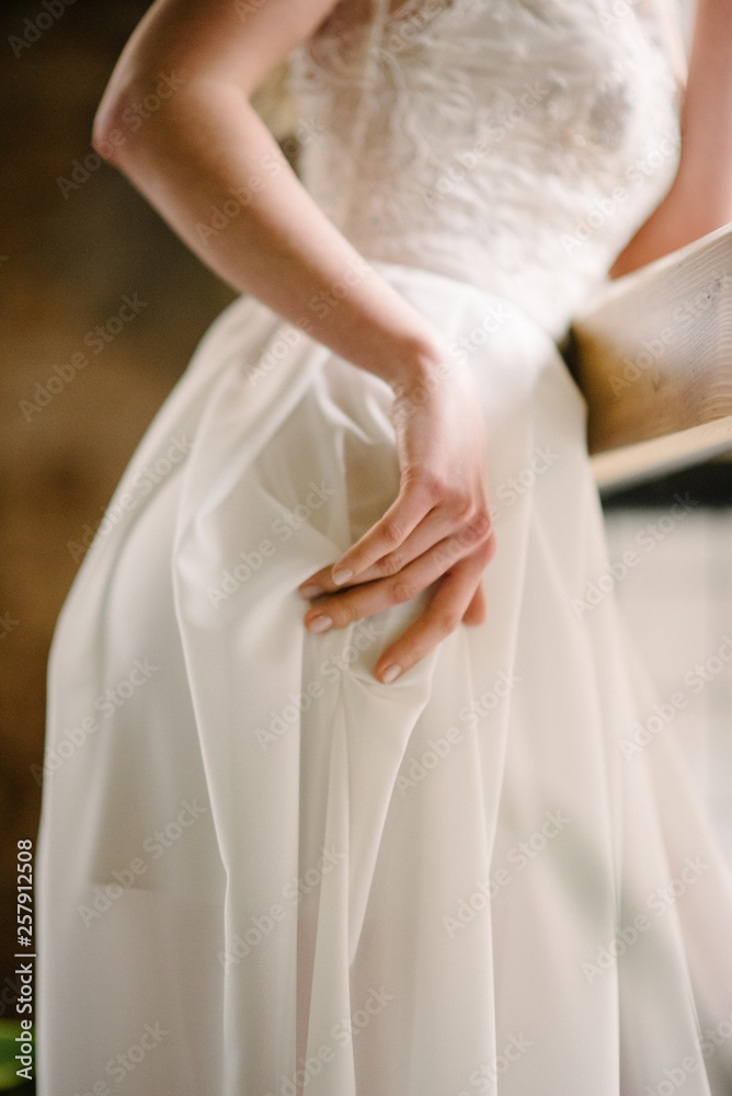 Hand on a white dress. Advertising of wedding dresses Hand on a white dress. Advertising of wedding dresses
