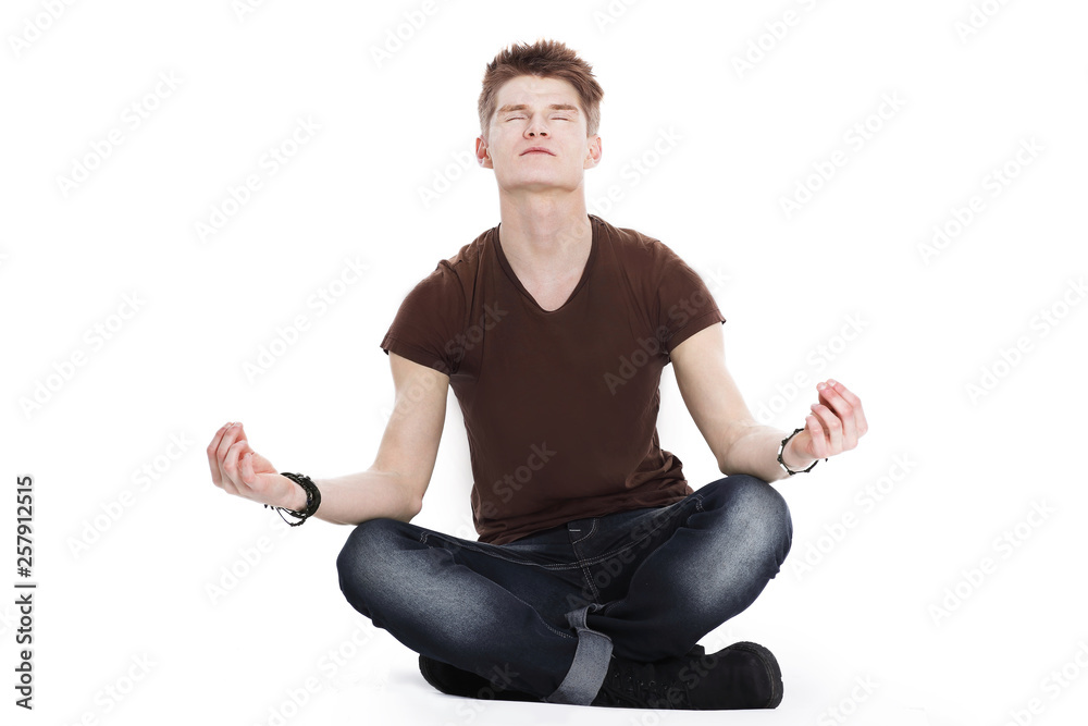 modern guy meditates sitting on the floor modern guy meditates sitting on the floor