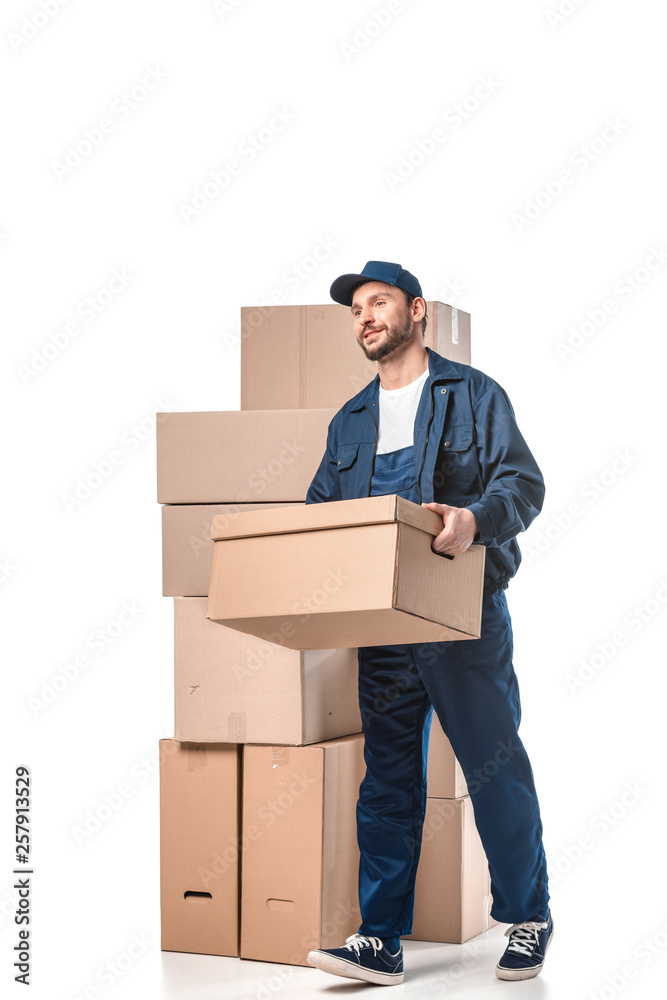 handsome mover in uniform carrying cardboard box isolated on white handsome mover in uniform carrying cardboard box isolated on white