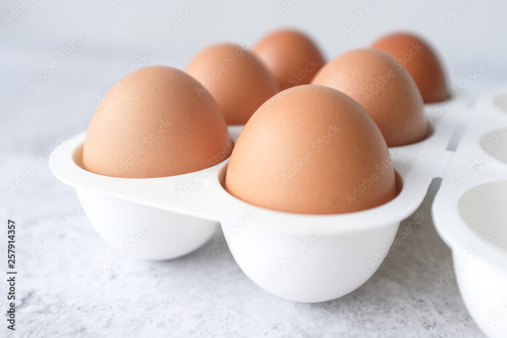 Eggs on light white and grey concrete table top with copy space on white wall blurred background. Closeup, selective focus. Eggs on light white and grey concrete table top with copy space on white wall blurred background. Closeup, selective focus.