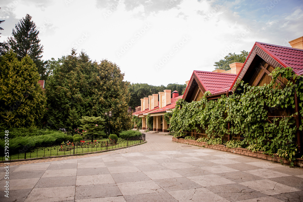 small one-storey houses on the street with lots of trees. quiet residential area