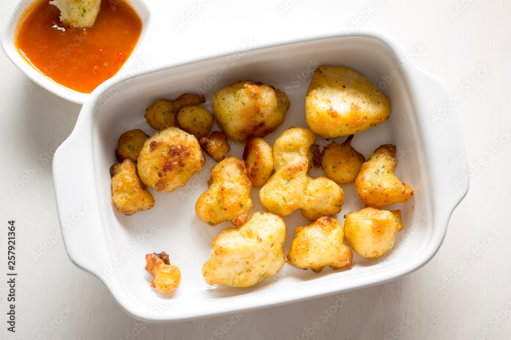 Cauliflower popcorn, coated mini cauliflower florets in a light batter with a spicy Buffalo dip Cauliflower popcorn, coated mini cauliflower florets in a light batter with a spicy Buffalo dip