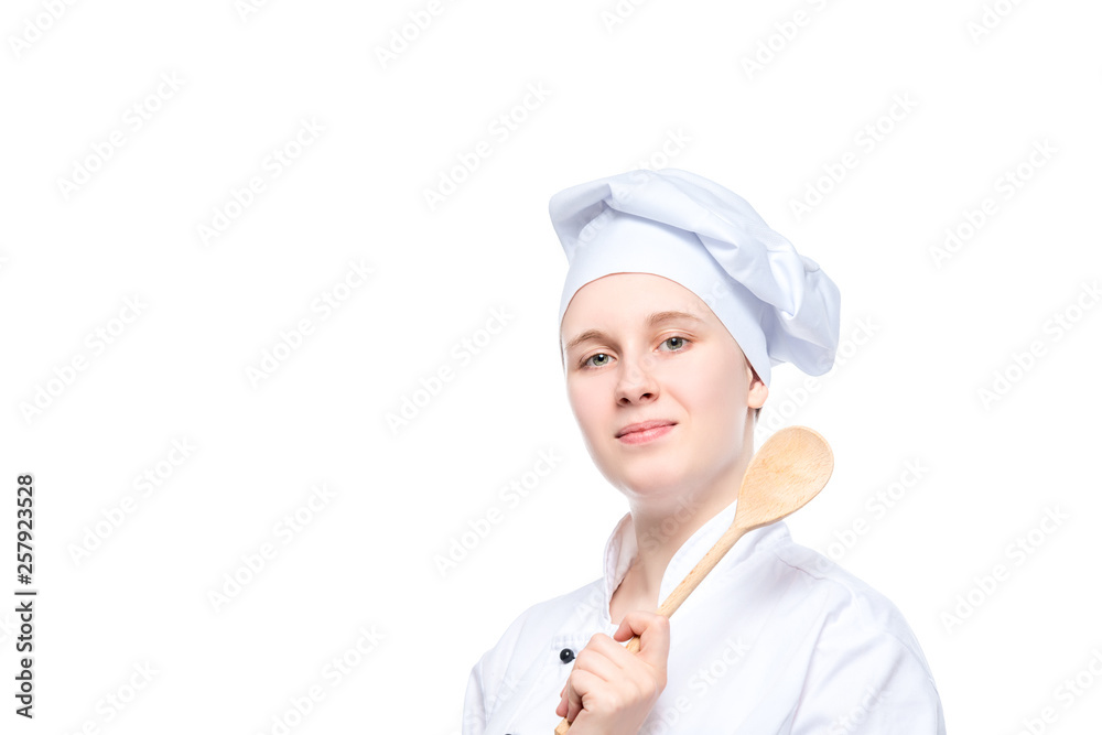 isolated portrait of a happy dreaming cook with a wooden spoon, a place for the inscription on the left isolated portrait of a happy dreaming cook with a wooden spoon, a place for the inscription on the left