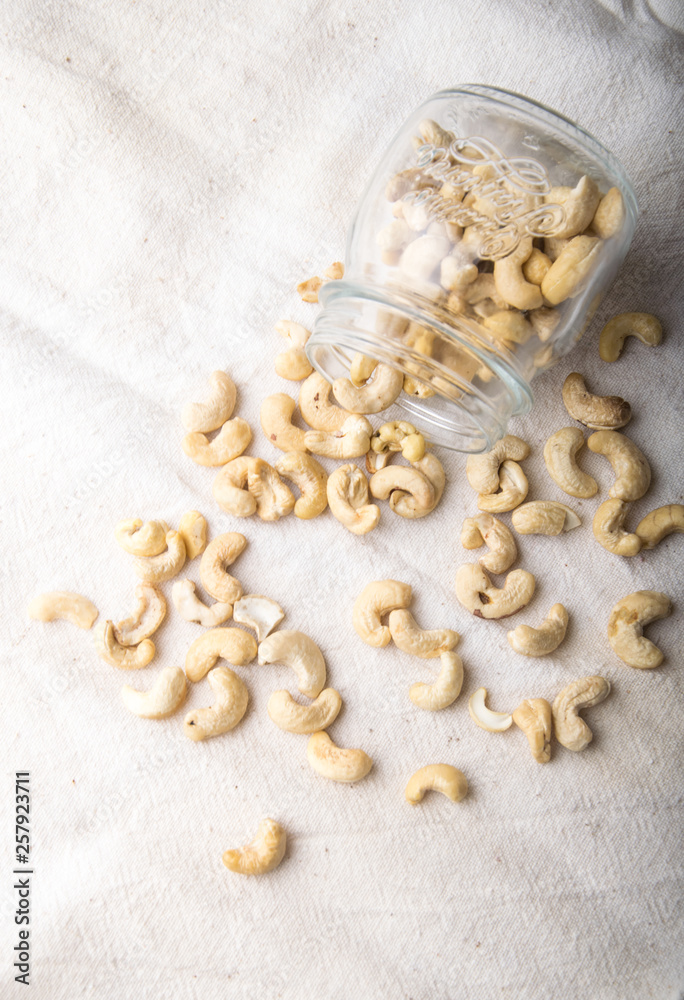 cashew nuts in a glass jar and on a table