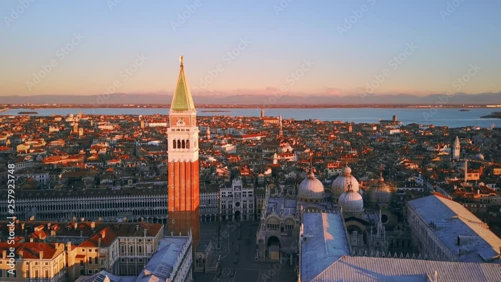 venice city skyline aerial view drone flying backwards over city from st mark square at sunrise italy