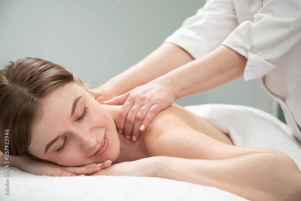 Young woman relaxing with hand massage at beauty spa. Young woman relaxing with hand massage at beauty spa.