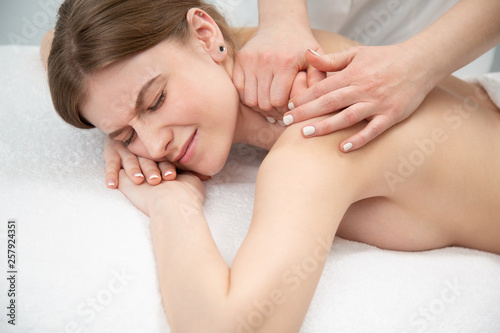 Young woman relaxing with hand massage at beauty spa.