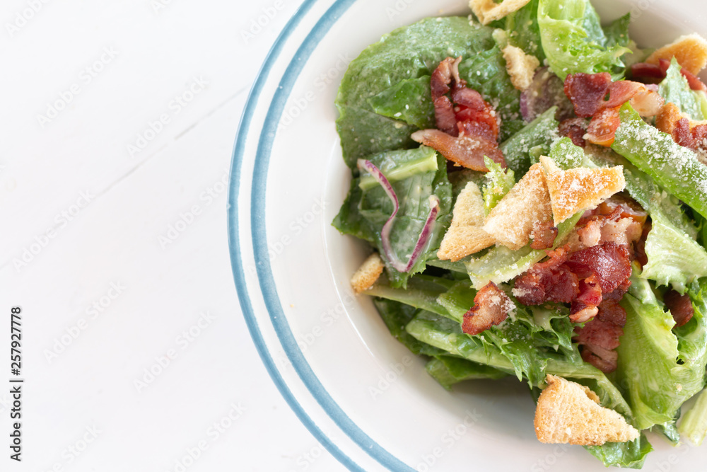 Closeup of healthy Caesar salad with croutons and Ham sliced Closeup of healthy Caesar salad with croutons and Ham sliced