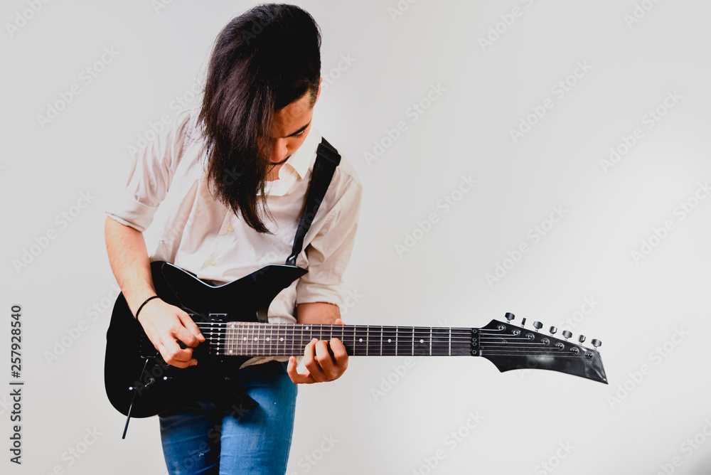 Young guitar player isolated on white background. Young guitar player isolated on white background.