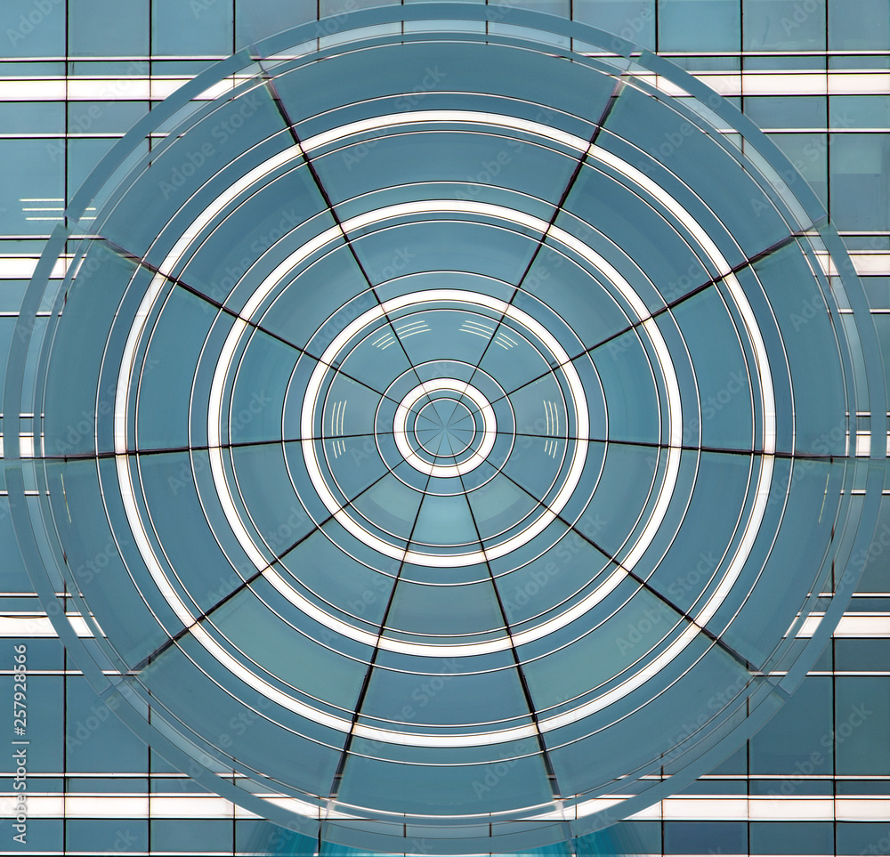 The blue circle of deformed windows on background of house facade. The blue circle of deformed windows on background of house facade.