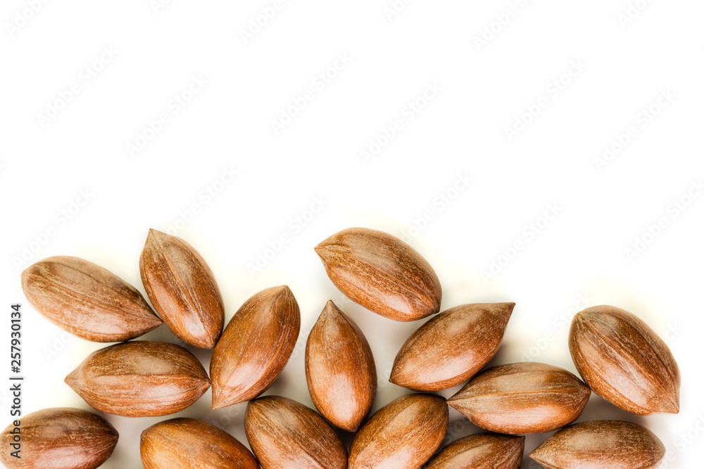Not cleaned pecan nuts in the shell isolated on white. Not cleaned pecan nuts in the shell isolated on white.