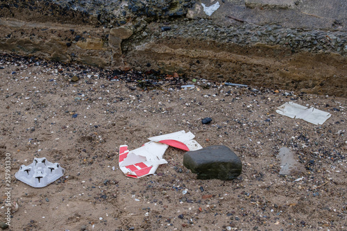 Waste being Discarded on the Beach with Cardboard and Plastic being Visable in tbe image. photo