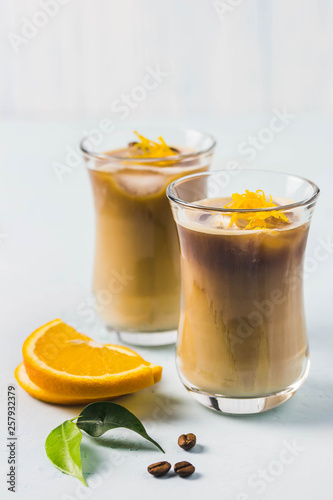 Orange iced latte. Selective focus, space for text.