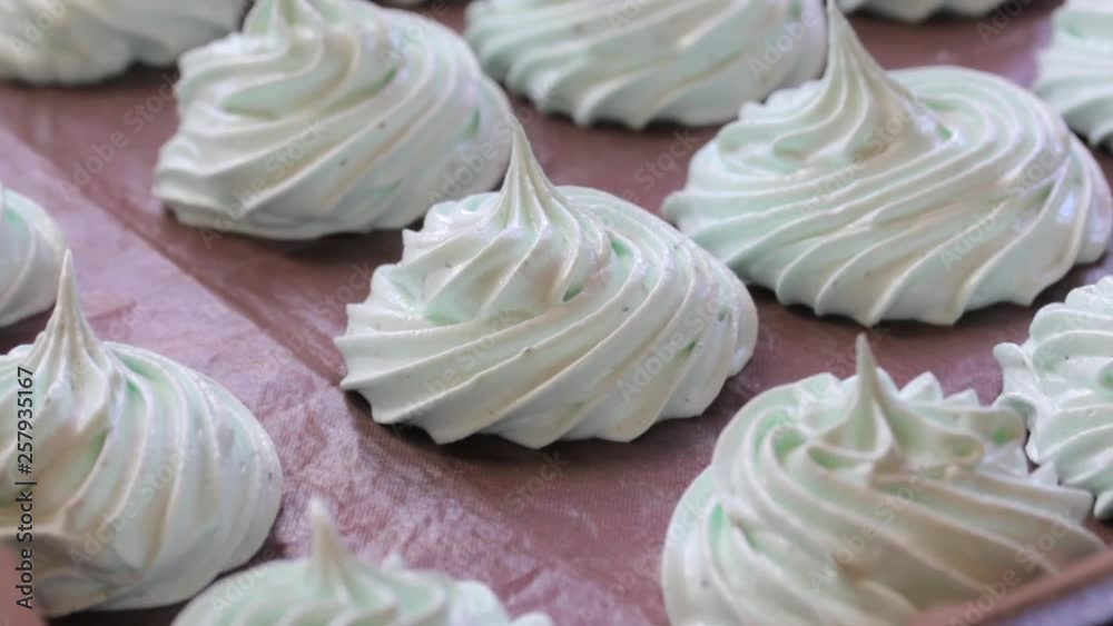 Freshly prepared marshmallows are laid on a flat surface to set. Hitting the camera Freshly prepared marshmallows are laid on a flat surface to set. Hitting the camera