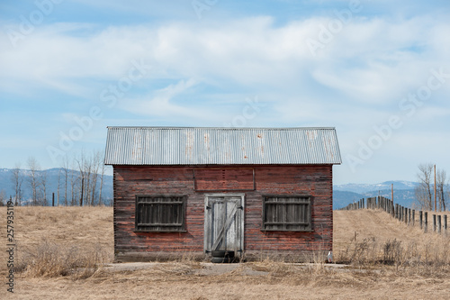 View of barn on farm against cloudy sky photo