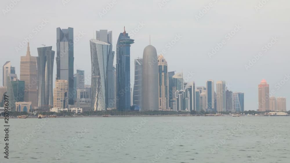 TIME LAPSE SUNSET TO NIGHT: capital city of Qatar, Doha West Bay skyline in Doha Bay. Panorama of glassed skyscrapers of Doha, Qatar, Middle East, Arabian Peninsula in Persian Gulf. Night urban scene TIME LAPSE SUNSET TO NIGHT: capital city of Qatar, Doha West Bay skyline in Doha Bay. Panorama of glassed skyscrapers of Doha, Qatar, Middle East, Arabian Peninsula in Persian Gulf. Night urban scene